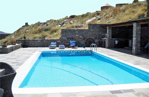 Koundouros Villa | Traditional stone built villa with a windmill and a swimming pool in Koundouros