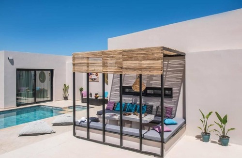 Skotino Villa | Villa with a sun terrace, garden, and a seasonal outdoor swimming pool.
