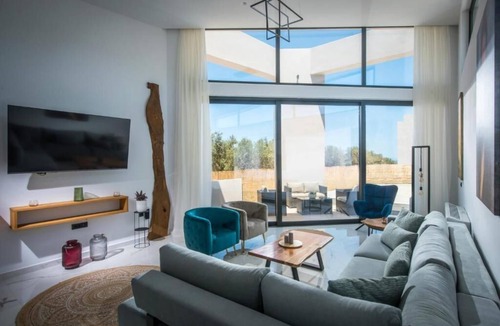 Skotino Villa | Villa with a sun terrace, garden, and a seasonal outdoor swimming pool.
