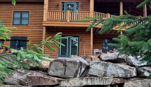 Luxury Log home steps from private beach in Meredith on Lake Winnipesaukee.